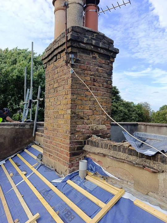 new beams and felt around chimney stack